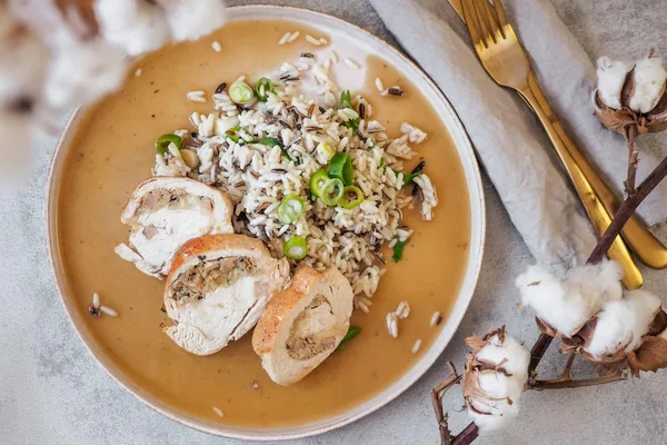 A plate of poultry roulade with rice and sauce, FOR HEALTH program